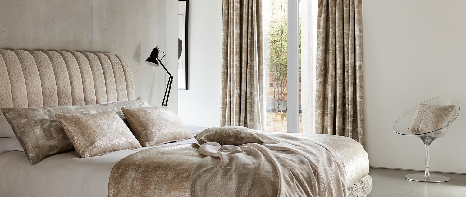 White and light gold bedding in bedroom